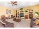 Comfortable living room with neutral carpet, built-in shelving, and plush seating at 10861 E Olla Ave, Mesa, AZ 85212