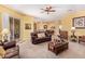 Open-concept living room with a ceiling fan and tile flooring at 10861 E Olla Ave, Mesa, AZ 85212