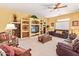 Spacious living room featuring a ceiling fan and built-in shelving at 10861 E Olla Ave, Mesa, AZ 85212