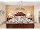 Elegant main bedroom with a decorative headboard, side tables, and lamps, creating a calming and inviting atmosphere at 10861 E Olla Ave, Mesa, AZ 85212