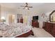 A serene main bedroom with ample closet space, a television, and neutral decor for a peaceful retreat at 10861 E Olla Ave, Mesa, AZ 85212