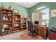 Inviting home office with built-in bookshelves, a comfortable workspace, and a window for natural light at 10861 E Olla Ave, Mesa, AZ 85212