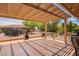 Inviting covered patio, perfect for outdoor relaxation with view of landscaped backyard at 10861 E Olla Ave, Mesa, AZ 85212
