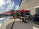 Backyard pool and patio with outdoor dining and seating, and a grill area at 1194 E Coyote Creek Way, San Tan Valley, AZ 85143