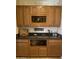 Bar area with wooden cabinets, granite countertops, and wine storage at 1194 E Coyote Creek Way, San Tan Valley, AZ 85143