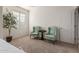 Cozy bedroom seating area with two wingback chairs and a view from the large window at 1194 E Coyote Creek Way, San Tan Valley, AZ 85143