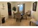 Elegant dining room featuring a glass table, upholstered chairs, and chandelier lighting at 1194 E Coyote Creek Way, San Tan Valley, AZ 85143