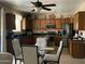 Eat-in kitchen features wood cabinetry, granite countertops, stainless steel appliances, and ceiling fan at 1194 E Coyote Creek Way, San Tan Valley, AZ 85143