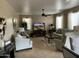 Cozy living room with comfortable seating, neutral tones, and a ceiling fan at 1194 E Coyote Creek Way, San Tan Valley, AZ 85143