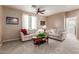 Comfortable living room featuring two sofas and a coffee table with a lush green plant at 1194 E Coyote Creek Way, San Tan Valley, AZ 85143