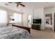 Bright main bedroom featuring a ceiling fan and ensuite bath with a carpeted floor at 1194 E Coyote Creek Way, San Tan Valley, AZ 85143