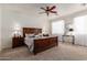 Spacious main bedroom suite with ceiling fan and bedside lamps at 1194 E Coyote Creek Way, San Tan Valley, AZ 85143