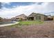 Enjoy a private backyard with a pool, covered patio, and low-maintenance desert landscaping at 14091 W Bloomfield Rd, Surprise, AZ 85379