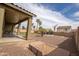Backyard showcases patio, desert landscaping, palms, and brick accents at 14091 W Bloomfield Rd, Surprise, AZ 85379