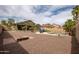 Backyard with desert landscaping, mature trees, and seating area at 14091 W Bloomfield Rd, Surprise, AZ 85379