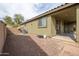 The backyard view displays patio, desert landscaping and brick accents at 14091 W Bloomfield Rd, Surprise, AZ 85379