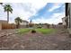 Expansive backyard featuring desert landscaping, palm trees, a refreshing pool, and plenty of space to enjoy at 14091 W Bloomfield Rd, Surprise, AZ 85379