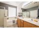 Bright bathroom with double vanity, tub, and walk-in shower; a serene and functional space at 14091 W Bloomfield Rd, Surprise, AZ 85379