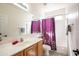 Bright bathroom with a shower-tub combination, vanity, and neutral finishes at 14091 W Bloomfield Rd, Surprise, AZ 85379