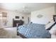 Spacious bedroom with a ceiling fan, dresser, carpeted floors, and a glass door to the patio at 14091 W Bloomfield Rd, Surprise, AZ 85379