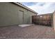 Exterior shot of backyard door, gated area, and access to outdoor space with low-maintenance landscaping at 14091 W Bloomfield Rd, Surprise, AZ 85379