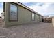 Side exterior view of home showing neutral paint, backyard, gated area, and easy access at 14091 W Bloomfield Rd, Surprise, AZ 85379