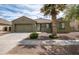 Charming single-Gathering home featuring a well-maintained yard with desert landscaping and a two-car garage at 14091 W Bloomfield Rd, Surprise, AZ 85379