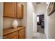 Hallway with overhead cabinets that lead to a carpeted bedroom at 14091 W Bloomfield Rd, Surprise, AZ 85379
