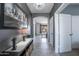 Stylish hallway with tiled flooring, modern decor, and an open doorway to the living area at 14091 W Bloomfield Rd, Surprise, AZ 85379