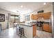 Well-appointed kitchen with stainless steel appliances, ample counter space, and a dining area at 14091 W Bloomfield Rd, Surprise, AZ 85379