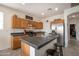 Well-lit kitchen boasts an island with seating and stainless steel appliances at 14091 W Bloomfield Rd, Surprise, AZ 85379