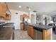 Bright kitchen with stainless steel appliances and center island open to living spaces at 14091 W Bloomfield Rd, Surprise, AZ 85379