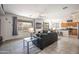 Bright and spacious living room with plush seating, modern decor, and an open layout to the kitchen at 14091 W Bloomfield Rd, Surprise, AZ 85379