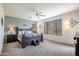 Main bedroom with a ceiling fan, generous natural light, and neutral carpeting at 14091 W Bloomfield Rd, Surprise, AZ 85379
