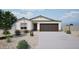 Charming single-story home featuring a neutral color palette, desert landscaping and a two-car garage at 1442 W Tigua Way, Coolidge, AZ 85128