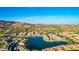 Wide aerial shot of a lakeside community with homes, mountains, and a picturesque lake at 16226 S 11Th Pl, Phoenix, AZ 85048