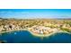 Expansive aerial view of a meticulously planned community nestled around a scenic lake with a fountain at 16226 S 11Th Pl, Phoenix, AZ 85048
