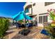 Spacious backyard patio with an umbrella, fire pit, and outdoor furniture at 16226 S 11Th Pl, Phoenix, AZ 85048