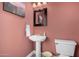 Powder room with pedestal sink, decorative mirror, paint in neutral tone, and tile flooring at 16226 S 11Th Pl, Phoenix, AZ 85048