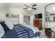 Bright bedroom with ceiling fan, a dresser and television, and walk-in closet at 16226 S 11Th Pl, Phoenix, AZ 85048