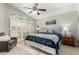 Bedroom features a ceiling fan, stained glass window, and a seating area at 16226 S 11Th Pl, Phoenix, AZ 85048