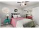 Bedroom featuring a ceiling fan, round window, a painting, and sliding mirror closet at 16226 S 11Th Pl, Phoenix, AZ 85048