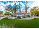 Scenic community entrance featuring lush landscaping, mature trees, and stylish signage, creating a welcoming atmosphere at 16226 S 11Th Pl, Phoenix, AZ 85048