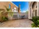 Private courtyard with a seating area, stone flooring, and lush palm trees at 16226 S 11Th Pl, Phoenix, AZ 85048