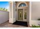 Elegant front door with arched window and decorative accents at 16226 S 11Th Pl, Phoenix, AZ 85048