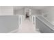 Second-floor hallway with glass railing and views of rooms beyond at 16226 S 11Th Pl, Phoenix, AZ 85048
