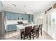 Bright kitchen features blue cabinets, white countertops, stainless steel appliances, and an island with seating at 16226 S 11Th Pl, Phoenix, AZ 85048