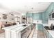 Bright, open kitchen with stainless steel appliances, blue cabinets, and island adjacent to the dining room at 16226 S 11Th Pl, Phoenix, AZ 85048