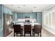 Modern kitchen with stainless steel appliances, blue cabinets, tile backsplash, and a large island with seating at 16226 S 11Th Pl, Phoenix, AZ 85048