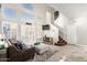 Bright living room featuring high ceilings, large windows with shutters, and a staircase with a patterned carpet at 16226 S 11Th Pl, Phoenix, AZ 85048